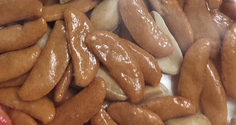 A close-up of Kaki no Tane, a Japanese rice cracker snack mixed with peanuts—crunchy, salty, and iconic.